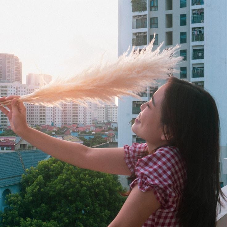 Kaveri Mehta, Lead Design Curator at OrchardTrailSun, reviewing corporate floral arrangements